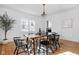 Bright dining room with hardwood floors, large table and modern chandelier at 4310 Central Ave, Indianapolis, IN 46205
