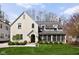 Charming two-story home featuring a well-manicured lawn, stucco exterior, and cozy screened porch at 4310 Central Ave, Indianapolis, IN 46205