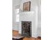 Living room fireplace with tile surround, white mantel, and a decorative art piece at 4310 Central Ave, Indianapolis, IN 46205
