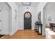Bright foyer with wood floors, a round-window door, and arched openings, creating a welcoming entrance at 4310 Central Ave, Indianapolis, IN 46205