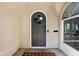 Charming entryway with a round-window door, classic hardware, and a brick landing, showcasing timeless elegance at 4310 Central Ave, Indianapolis, IN 46205
