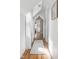 Bright hallway features hardwood floors, white walls, and natural light through the window at 4310 Central Ave, Indianapolis, IN 46205
