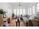 Sun-drenched living room featuring hardwood floors, neutral decor, and large windows for ample natural light at 4310 Central Ave, Indianapolis, IN 46205