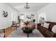 Spacious living room featuring hardwood floors, neutral décor, and a glimpse into adjoining dining area at 4310 Central Ave, Indianapolis, IN 46205