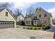 View of the rear of the home with detached garage and concrete driveway at 4310 Central Ave, Indianapolis, IN 46205