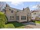 Back of a two-story home featuring a black roof, manicured lawn, and string lights at 4310 Central Ave, Indianapolis, IN 46205
