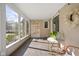 Bright sunroom with tile floor, plenty of sunlight and cozy chair at 4310 Central Ave, Indianapolis, IN 46205