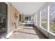 Inviting sunroom with tile floor, plenty of sunlight and a cozy porch swing at 4310 Central Ave, Indianapolis, IN 46205