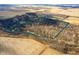 An aerial view showcases the property's wooded lot with river running through, bordered by open fields at 4543 E 700 N, Alexandria, IN 46001