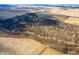 An expansive aerial view revealing an open landscape with farm land and some trees at 4543 E 700 N, Alexandria, IN 46001