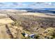 A stunning aerial view captures the beauty of a lush property with a blend of open fields and wooded areas at 4543 E 700 N, Alexandria, IN 46001