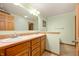 Bright bathroom featuring a double vanity with oak cabinets and a large mirror at 4543 E 700 N, Alexandria, IN 46001