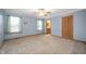 Spacious bedroom with two windows, soft blue walls, ceiling fan and a door leading to the bathroom at 4543 E 700 N, Alexandria, IN 46001