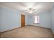 Comfortable bedroom featuring a ceiling fan, single window with curtains and soft blue walls at 4543 E 700 N, Alexandria, IN 46001