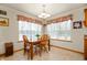 Sunlit dining area featuring a wooden table and chairs beneath a decorative window, perfect for Gathering meals at 4543 E 700 N, Alexandria, IN 46001