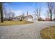 Ranch-style home with neutral siding, a detached garage, and a gravel driveway at 4543 E 700 N, Alexandria, IN 46001