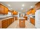 Bright, spacious kitchen features wood cabinets, central island, white appliances, and recessed lighting at 4543 E 700 N, Alexandria, IN 46001