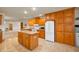 Well-lit kitchen boasts wood cabinets, an island with countertop, and appliances for functionality and style at 4543 E 700 N, Alexandria, IN 46001