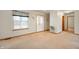 Bright living room featuring neutral carpet, a front entry, and a large window at 4543 E 700 N, Alexandria, IN 46001