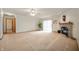 Spacious living room featuring neutral carpet, a fireplace, and sliding glass doors at 4543 E 700 N, Alexandria, IN 46001