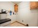 Utility room featuring water softener, mounted utility sink, and overhead storage at 4543 E 700 N, Alexandria, IN 46001