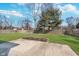 Spacious backyard featuring a well-maintained lawn, concrete patio, and wood fence at 4905 N Dearborn St, Indianapolis, IN 46205
