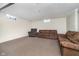 Finished basement featuring neutral carpet and two couches, offering additional living space at 4905 N Dearborn St, Indianapolis, IN 46205