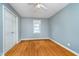 Bright bedroom with hardwood floors, closet, and a window for natural light at 4905 N Dearborn St, Indianapolis, IN 46205