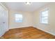 Comfortable bedroom featuring hardwood floors, a closet, and plenty of natural light at 4905 N Dearborn St, Indianapolis, IN 46205