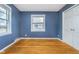 Bedroom with hardwood floors, natural light, and a closet with double doors at 4905 N Dearborn St, Indianapolis, IN 46205