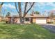 Charming brick home with a well-manicured lawn and mature trees in a peaceful neighborhood at 4905 N Dearborn St, Indianapolis, IN 46205