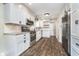 Bright, remodeled kitchen with white cabinets, granite counters, and stainless steel appliances at 4905 N Dearborn St, Indianapolis, IN 46205