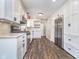 Bright, remodeled kitchen with white cabinets, granite counters, and stainless steel appliances at 4905 N Dearborn St, Indianapolis, IN 46205