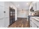 Bright kitchen featuring stainless steel appliances, white cabinets, and wood-look flooring at 4905 N Dearborn St, Indianapolis, IN 46205