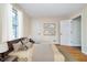 Calm, bright main bedroom with a large window, hardwood floors, and neutral decor create a peaceful retreat at 4905 N Dearborn St, Indianapolis, IN 46205