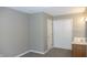 Bathroom featuring a double-door closet, a vanity with a sink, and neutral-colored walls and carpet at 540 Louise Dr, Indianapolis, IN 46217