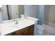 Bathroom featuring an oak vanity, white countertops, tub with shower, and tile flooring at 540 Louise Dr, Indianapolis, IN 46217