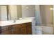 Bathroom featuring an oak vanity, white countertops, and tub with shower at 540 Louise Dr, Indianapolis, IN 46217