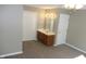 Bathroom with a double-door closet, vanity with sink, and neutral walls and carpet, complemented by a ceiling fan at 540 Louise Dr, Indianapolis, IN 46217