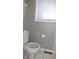 Bathroom featuring a standard white toilet beneath a window with blinds at 540 Louise Dr, Indianapolis, IN 46217