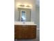 Bathroom vanity with a neutral-colored countertop, light fixtures, and a mirror above the sink at 540 Louise Dr, Indianapolis, IN 46217