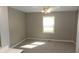 A well-lit bedroom featuring neutral walls, carpeted flooring, and a window allowing natural light at 540 Louise Dr, Indianapolis, IN 46217