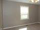 Bright bedroom with neutral walls and carpet, featuring a window providing natural light at 540 Louise Dr, Indianapolis, IN 46217