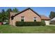 This brick home includes tidy hedges and manicured lawn at 540 Louise Dr, Indianapolis, IN 46217