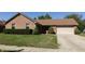 Charming brick home featuring a well-manicured lawn and attached two-car garage at 540 Louise Dr, Indianapolis, IN 46217