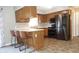 Updated kitchen with modern stainless steel appliances and breakfast bar at 540 Louise Dr, Indianapolis, IN 46217
