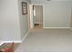 Open living room leads to bedroom and shows neutral carpeting at 540 Louise Dr, Indianapolis, IN 46217