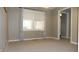 Bright living room showcasing large windows, neutral walls, and plush carpeting at 540 Louise Dr, Indianapolis, IN 46217