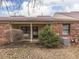 Cozy backyard with a covered patio, brick siding, and mature landscaping at 5457 Happy Hollow, Indianapolis, IN 46268