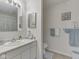 Bright bathroom featuring a vanity with a marble top and a decorative framed mirror on the wall at 5457 Happy Hollow, Indianapolis, IN 46268